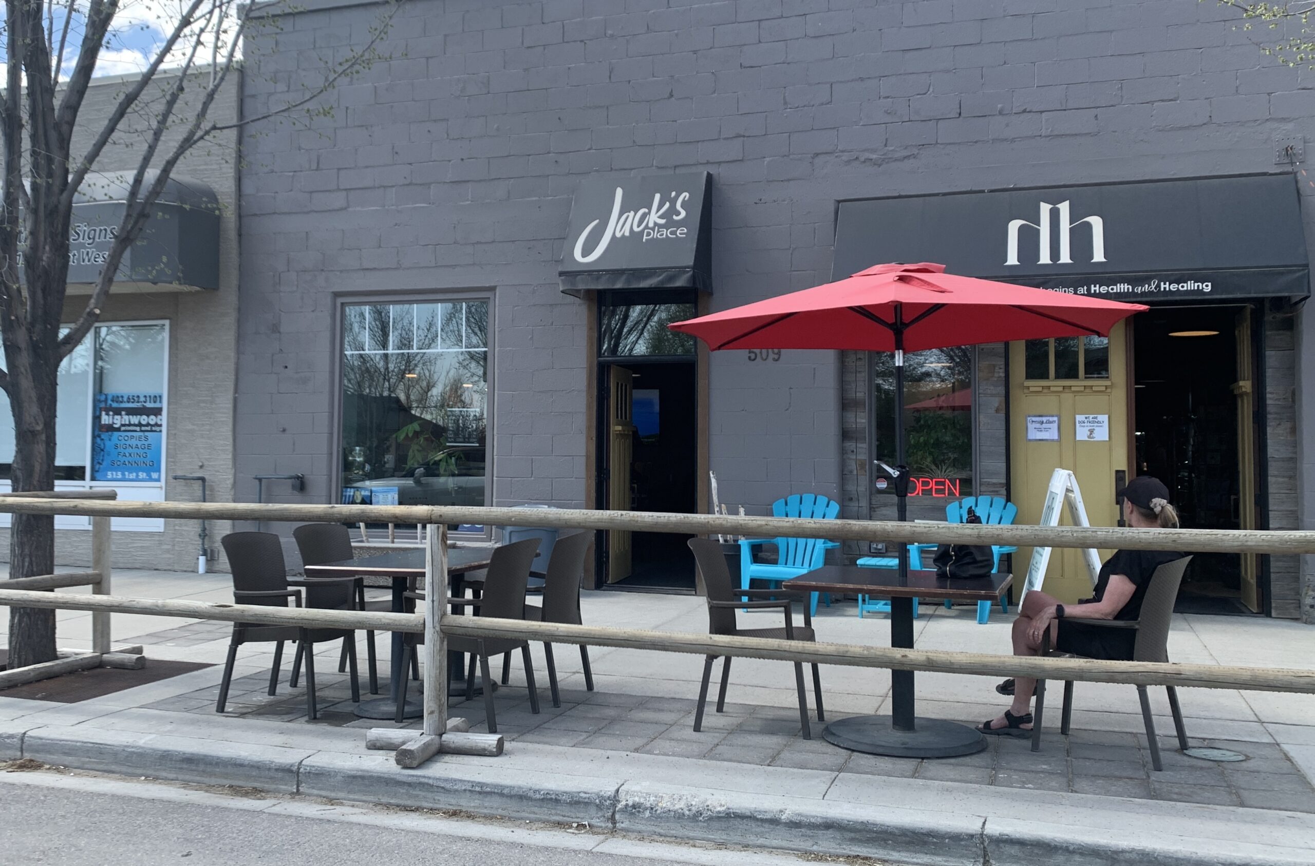 Jack's Place patio with teal Adirondack chairs in downtown High River Alberta