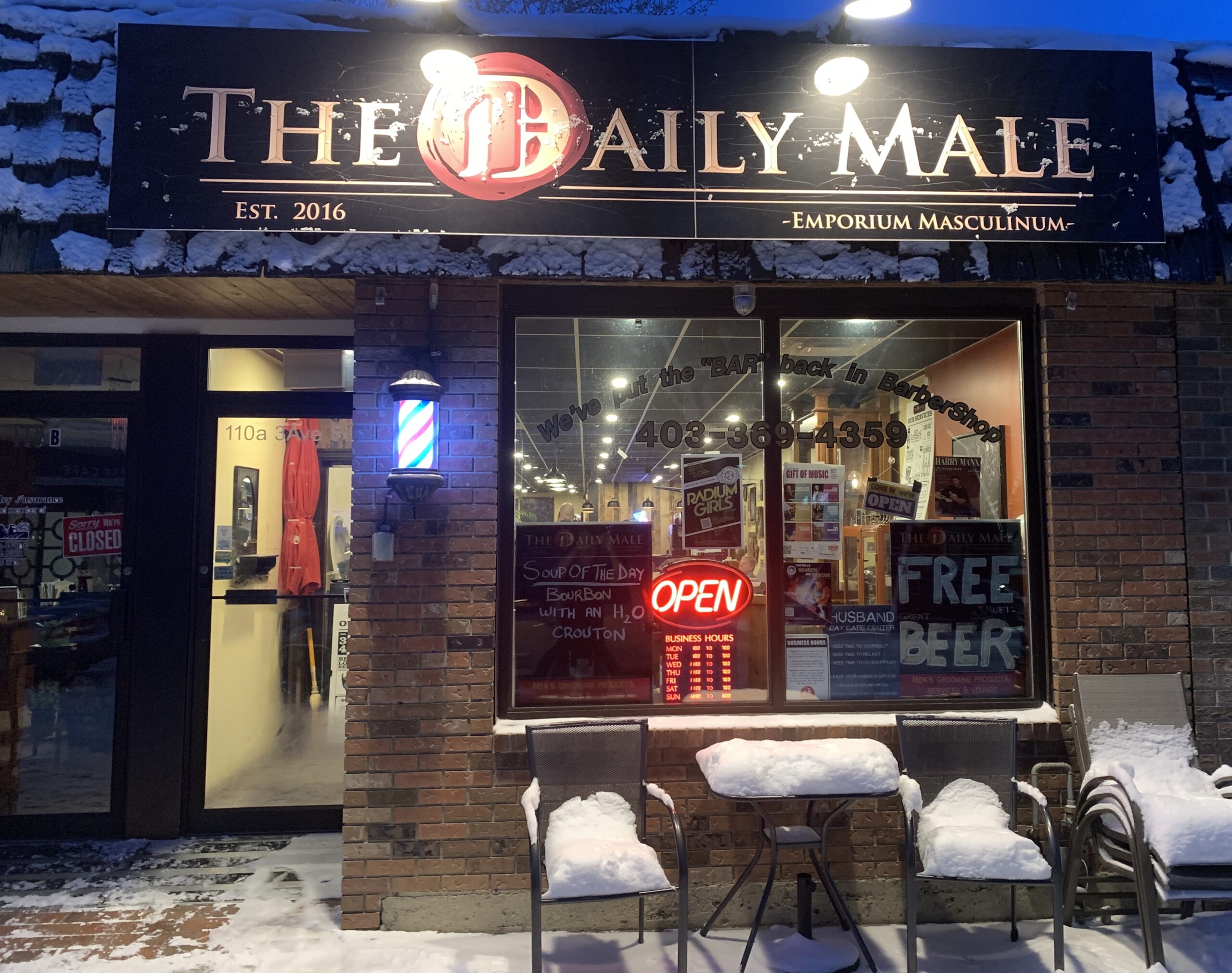 The Daily Male barbershop with barber pole and snow in High River Alberta