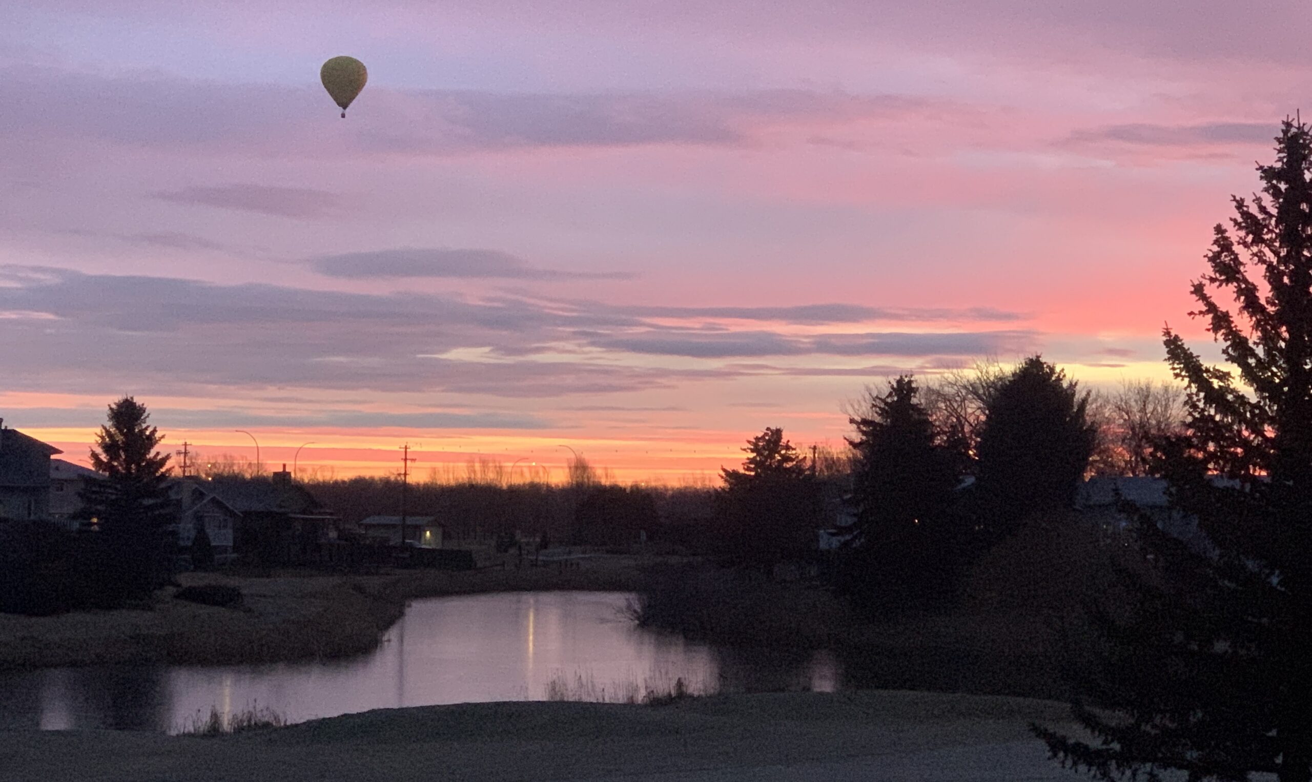 Sunset and hot air balloon over Highwood Golf Course, High River — view from Shawn Selanders' home office